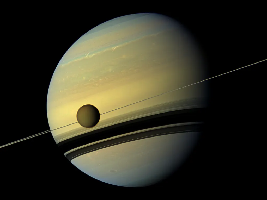 Saturn and its rings, with the moon Titan (NASA)